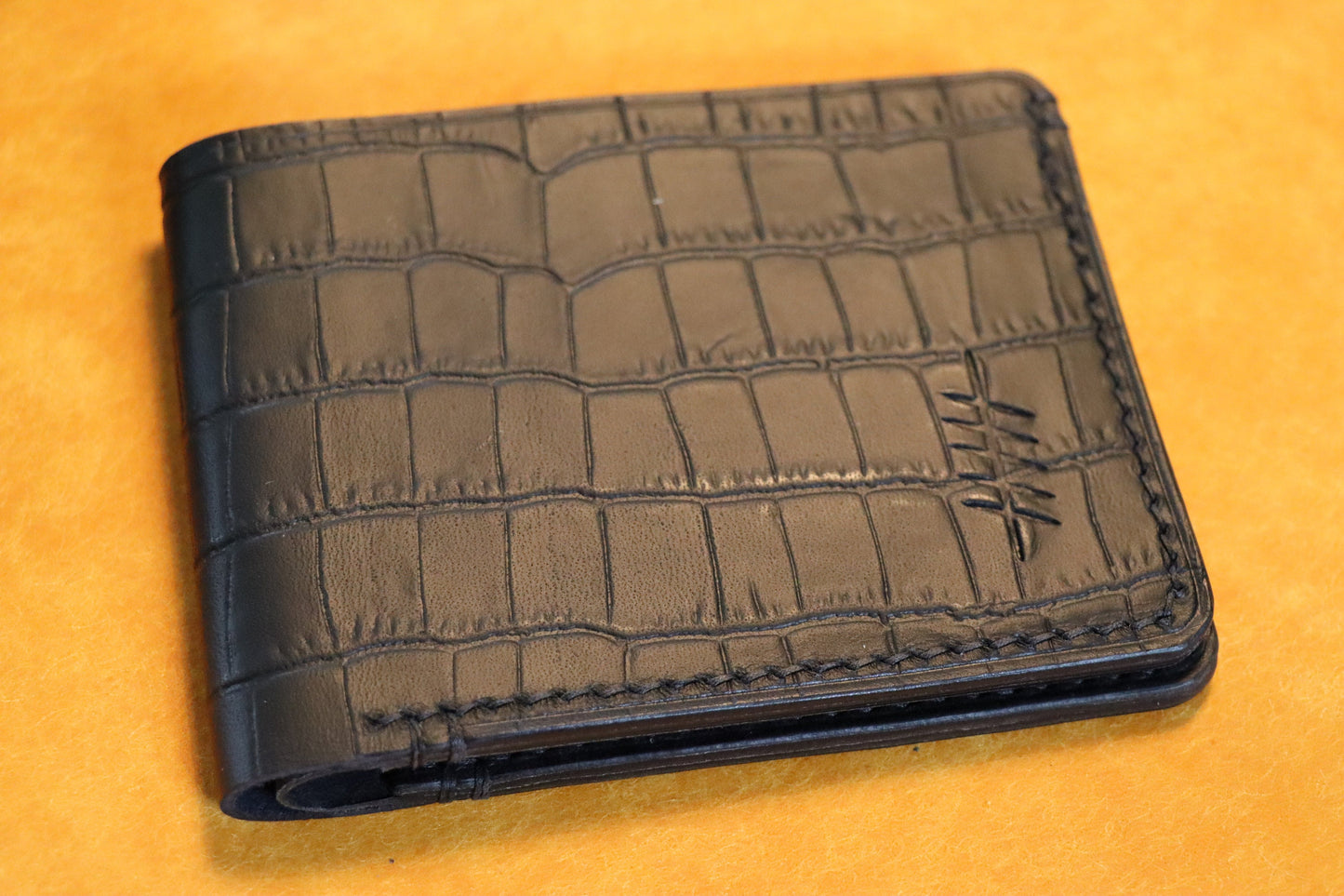 The Elder Bi-fold wallet in Crocodile Embossed Full grain Italian leather.