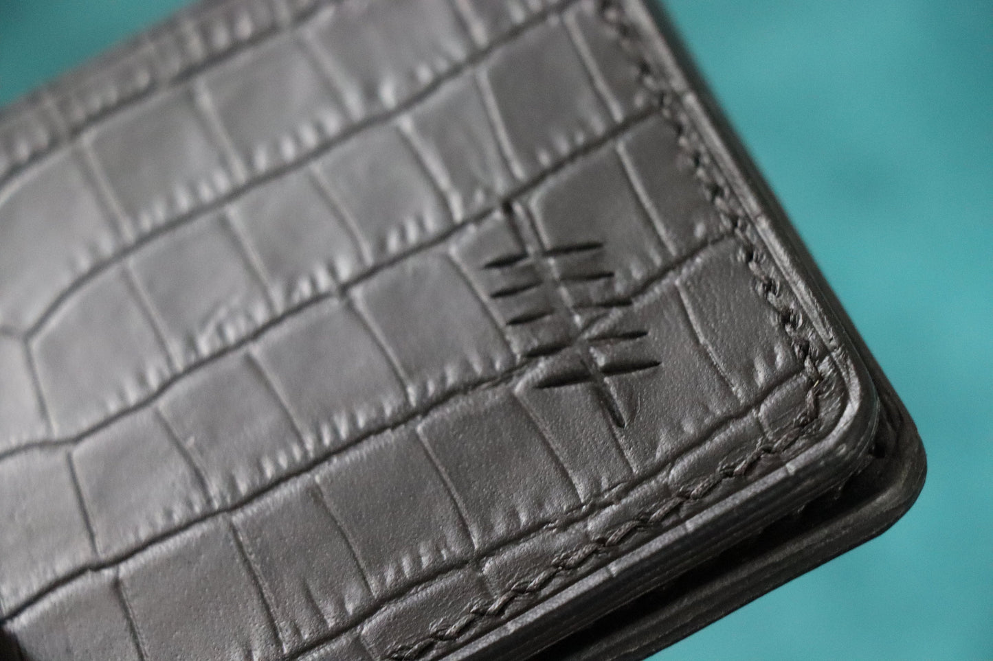 The Elder Bi-fold wallet in Crocodile Embossed Full grain Italian leather.